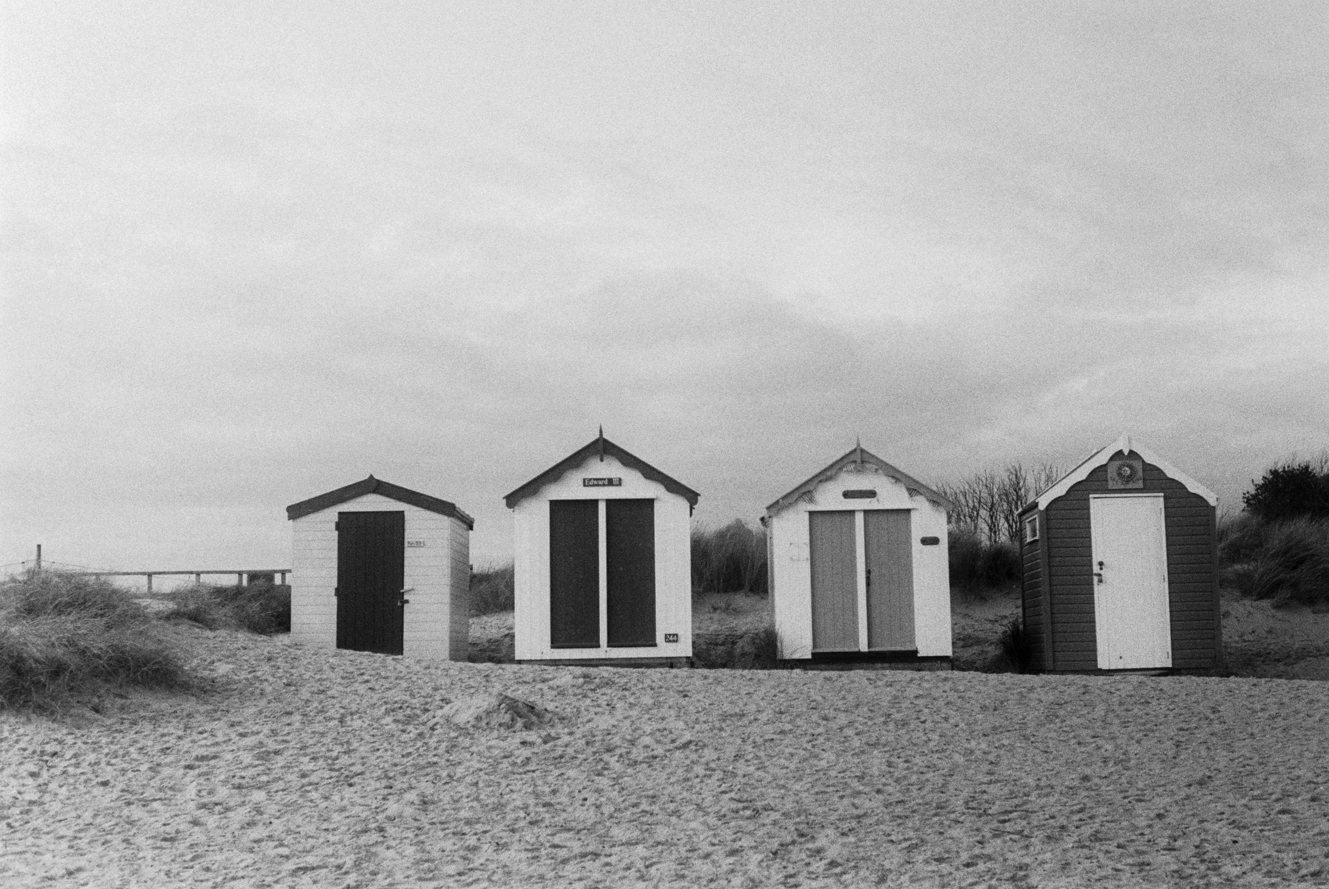 white and gray wooden house on body of water